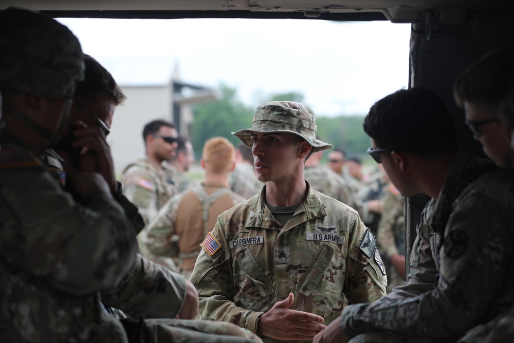 U.S. Army Sgt. Timothy Cassinera of Bravo Company, 2-285th Aviation Regiment, helps with training Soldiers