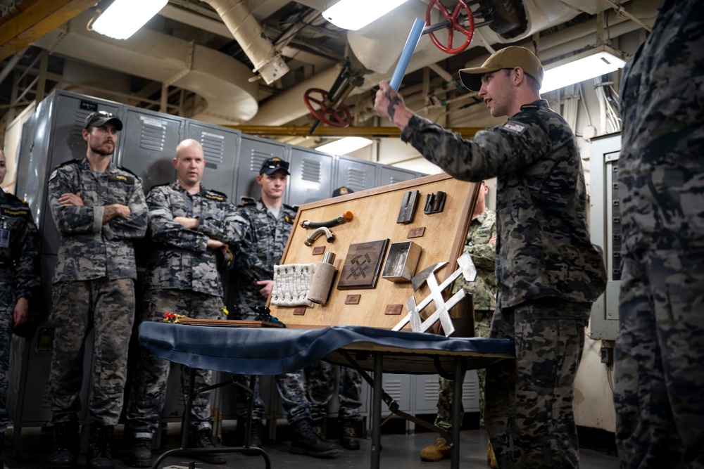 RAN sailors from Fleet Support Unit North, Fleet Logistic Support Element and Port Services during a tour of the tender