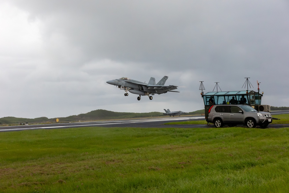 U.S. Marines, Sailors, and Japanese government officials visit Iwo Jima to observe Carrier Air Wing 5 field carrier landing practice.