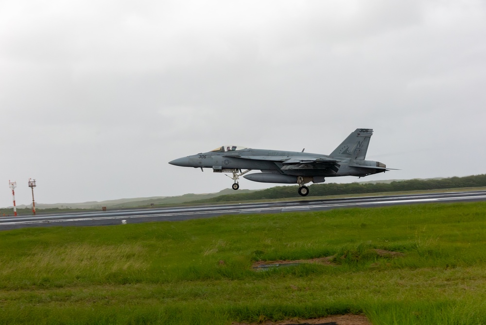 U.S. Marines, Sailors, and Japanese government officials visit Iwo Jima to observe Carrier Air Wing 5 field carrier landing practice.