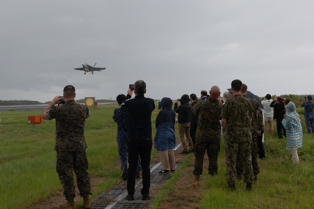 U.S. Marines, Sailors, and Japanese government officials visit Iwo Jima to observe Carrier Air Wing 5 field carrier landing practice.