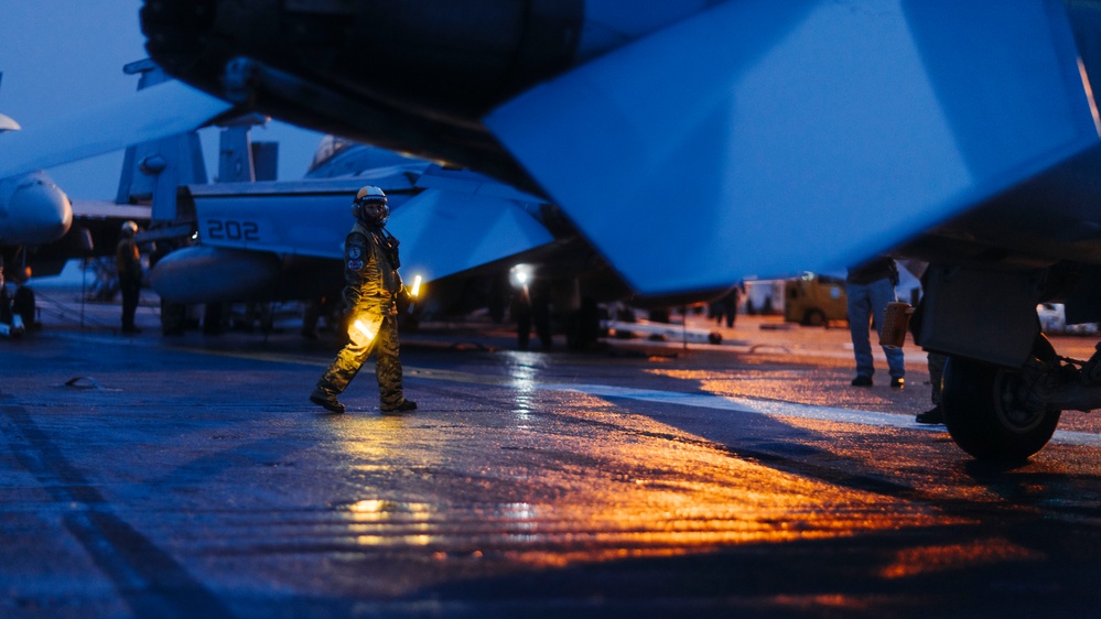 Aircraft Handlers Move Aircraft at Dawn