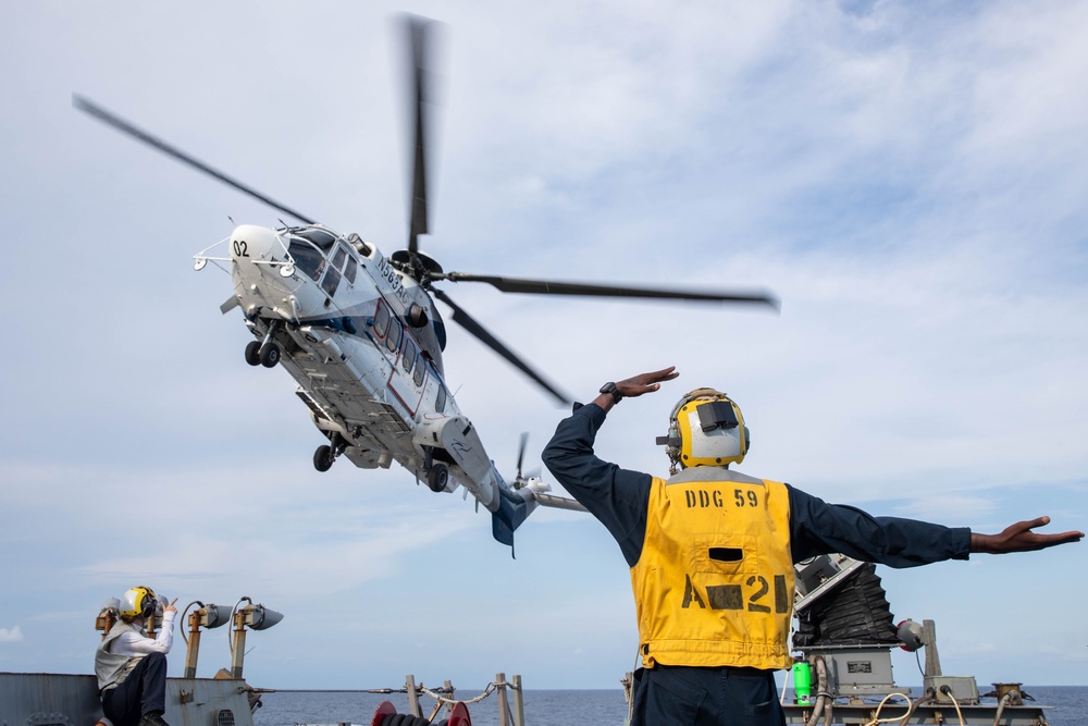 USS Russell (DDG 59) receives over 100 pallets worth of supplies during a vertical replenishment with USNS Wally Schirra (T-AKE 8)