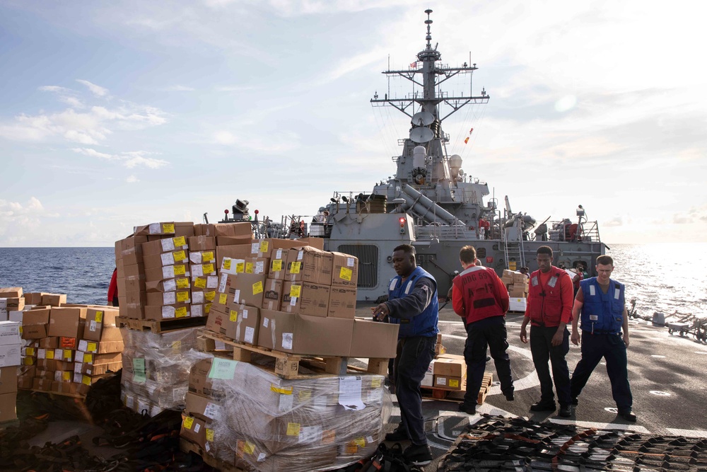 USS Russell (DDG 59) receives over 100 pallets worth of supplies during a vertical replenishment with USNS Wally Schirra (T-AKE 8)