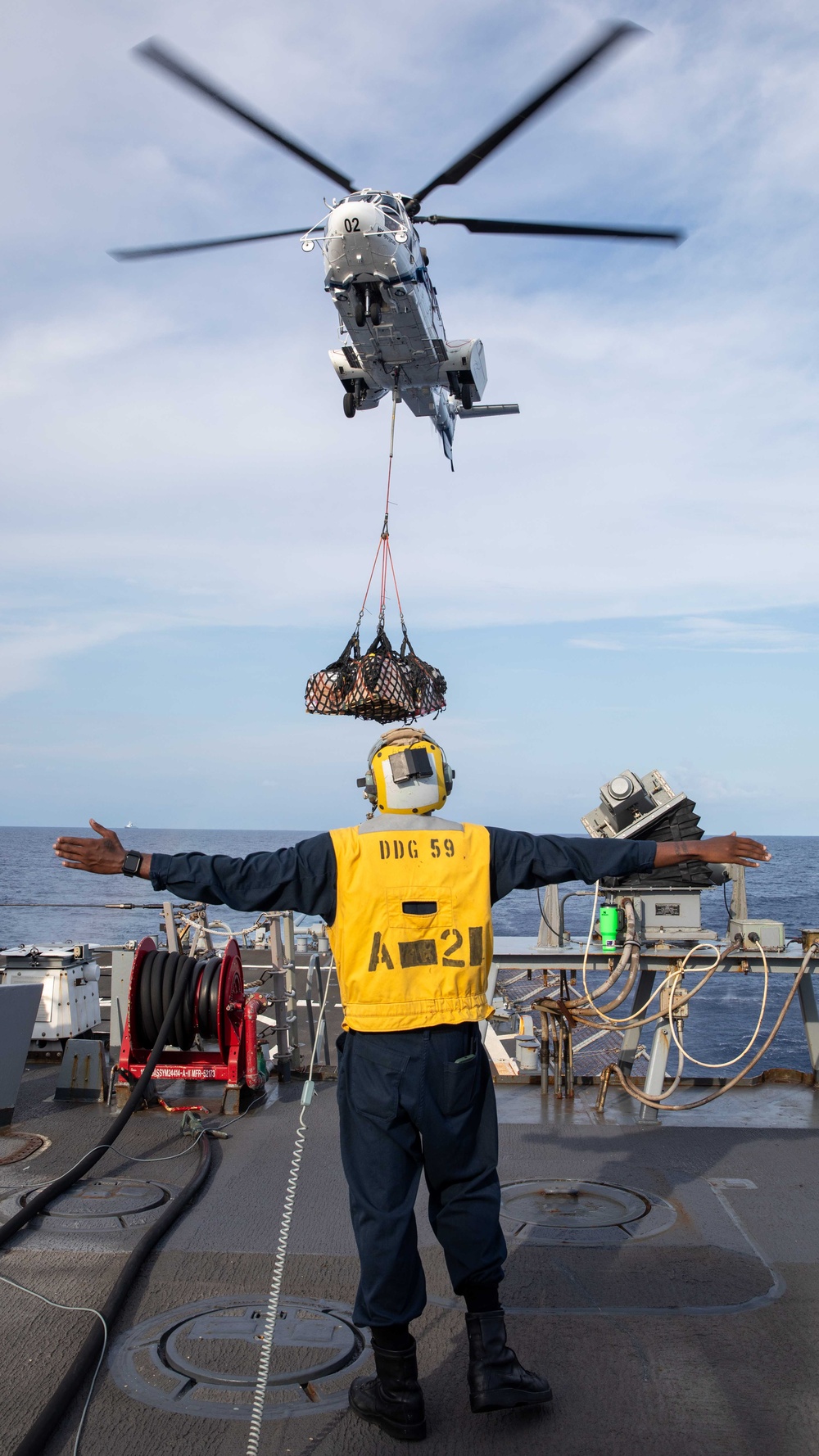 USS Russell (DDG 59) receives over 100 pallets worth of supplies during a vertical replenishment with USNS Wally Schirra (T-AKE 8)