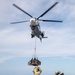 USS Russell (DDG 59) receives over 100 pallets worth of supplies during a vertical replenishment with USNS Wally Schirra (T-AKE 8)