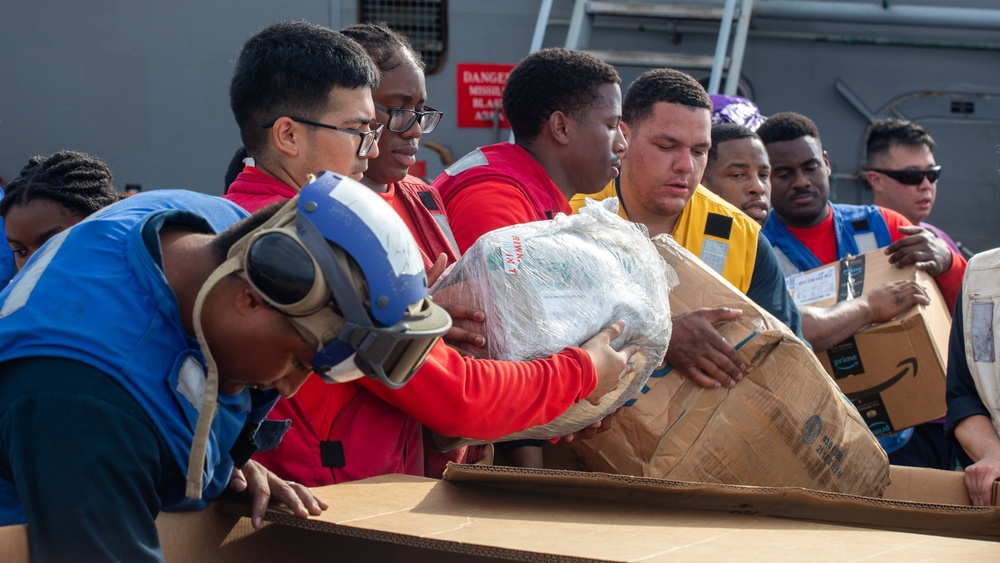 USS Russell (DDG 59) receives over 100 pallets worth of supplies during a vertical replenishment with USNS Wally Schirra (T-AKE 8)