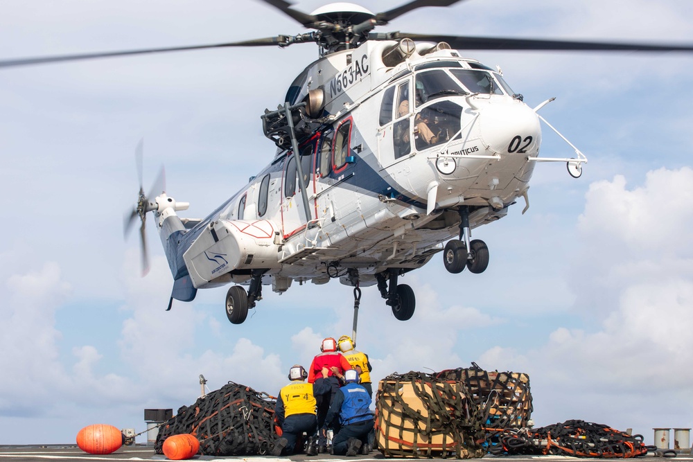 USS Russell (DDG 59) receives over 100 pallets worth of supplies during a vertical replenishment with USNS Wally Schirra (T-AKE 8)