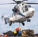 USS Russell (DDG 59) receives over 100 pallets worth of supplies during a vertical replenishment with USNS Wally Schirra (T-AKE 8)