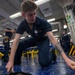 Midshipmen clean the mess decks aboard USS Tripoli