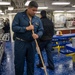 Midshipmen clean the mess decks aboard USS Tripoli