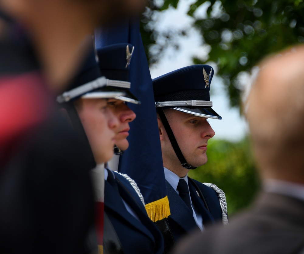 Airman looks on as Brig. Gen. Tomika Seaberry delivers speech during DDay 80