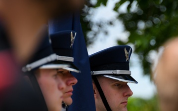 Airman looks on as Brig. Gen. Tomika Seaberry delivers speech during DDay 80