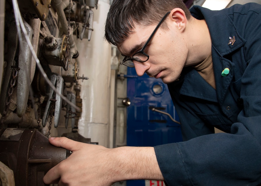 USS Carl Vinson (CVN 70) Sailor Performs Preventative Maintenance on a Fire Pump