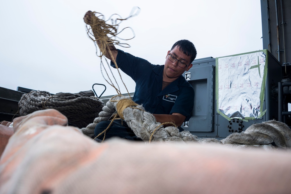 USS Carl Vinson (CVN 70) Sailor Repairs a Mooring Line