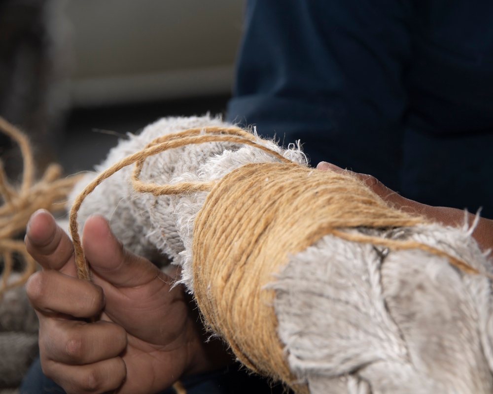 USS Carl Vinson (CVN 70) Sailor Repairs a Mooring Line