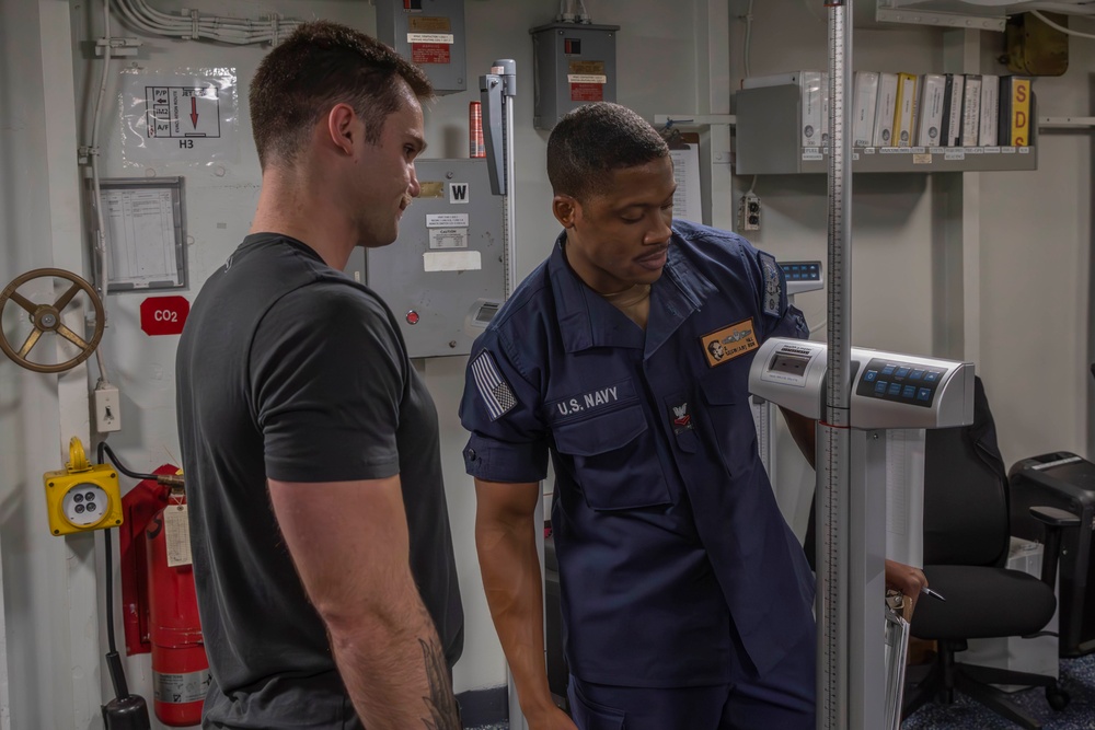 Sailors conduct body composition assessment aboard Abraham Lincoln