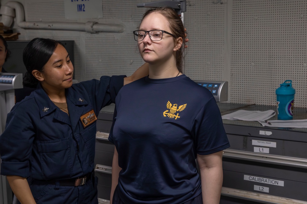 Sailors conduct body composition assessment aboard Abraham Lincoln