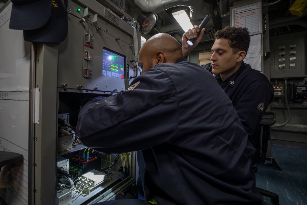 Sailors conduct electrical maintenance aboard Abraham Lincoln