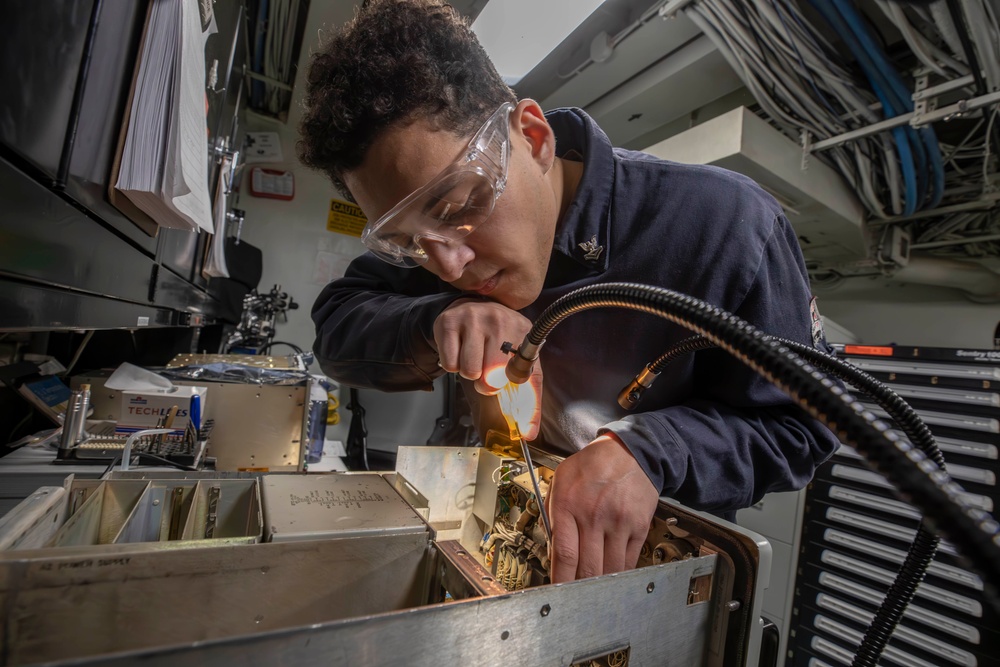 Sailor conducts electrical maintenance aboard Abraham Lincoln