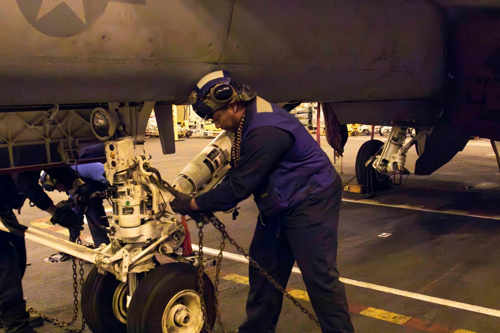 Sailors conduct aviation maintenance aboard Abraham Lincoln