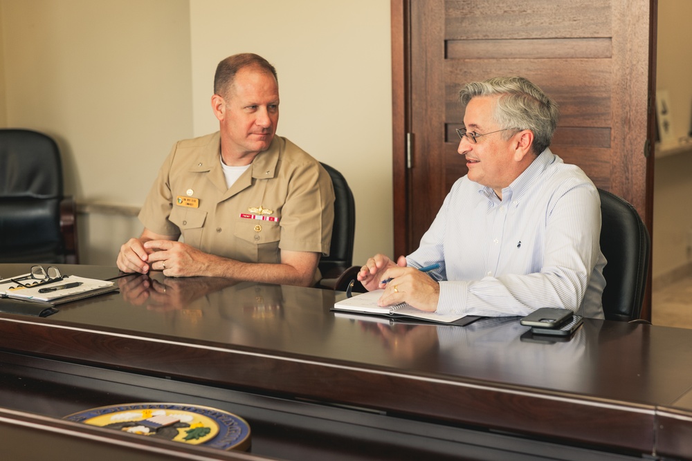 Rear Adm. Greg Huffman Introduces Rear Adm. Brent DeVore to Congressman Moylan in Guam