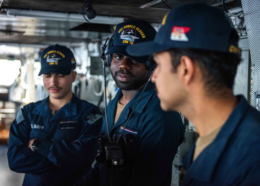 USS Ronald Reagan (CVN 76) Sailors stand watch in the  pilot house