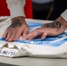 Sailor stencils jersey aboard Abraham Lincoln