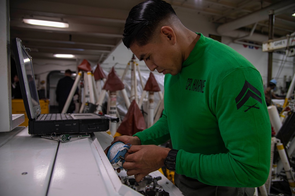 Marine conducts maintenance aboard Abraham Lincoln