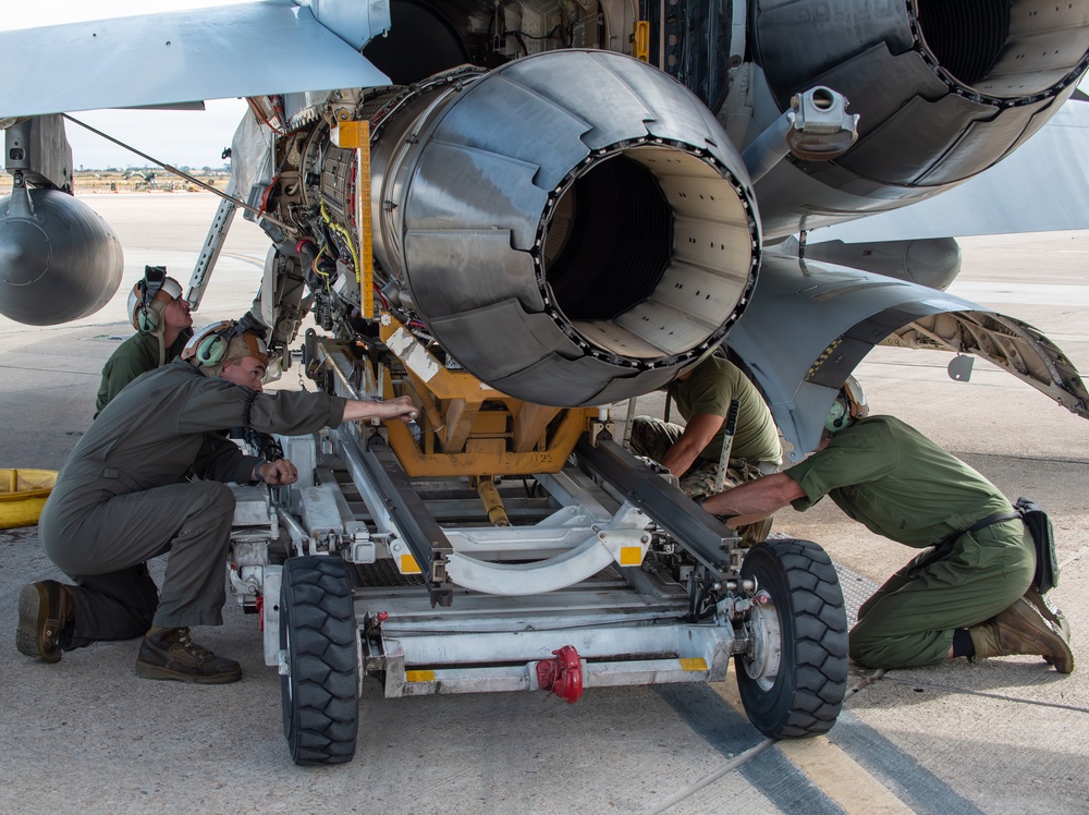 Powerline Marines work together to lower engine