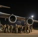 U.S. service members bid farewell to their teammates as they board the U.S. Air Force C-17 Globemaster III aircraft