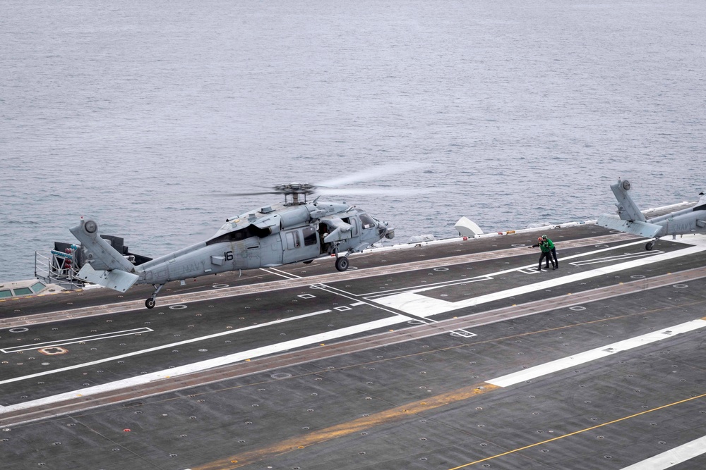 An MH-60S Sea Hawk, assigned to the “Black Knights” of Helicopter Sea Combat Squadron (HSC) 4, lands on the flight deck aboard Nimitz-class aircraft carrier USS Carl Vinson (CVN 70)