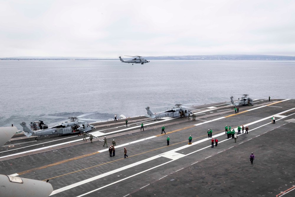 Sailors aboard Nimitz-class aircraft carrier USS Carl Vinson (CVN 70) transfer supplies from MH-60S Sea Hawks