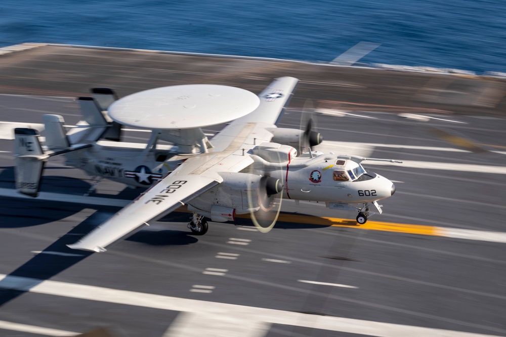 An E-2D Advanced Hawkeye lands on the flight deck of Nimitz-class aircraft carrier USS Carl Vinson (CVN 70)