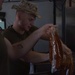 U.S. Marine food service specialists prepare evening chow at Integrated Training Exercise 4-24
