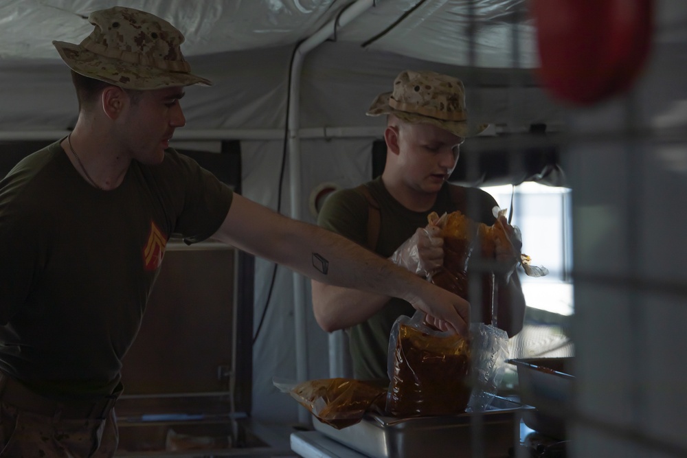 U.S. Marine food service specialists prepare evening chow at Integrated Training Exercise 4-24