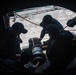 Sailors assigned to the USS America (LHA 6) handle a fueling hose