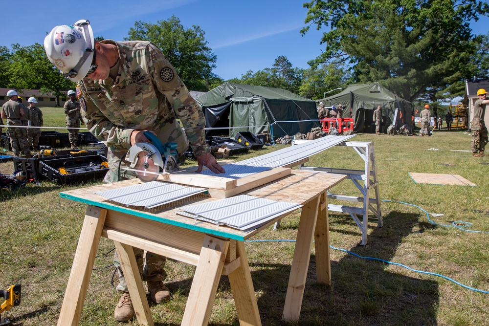 Soldier cuts new soffit for restoration of building