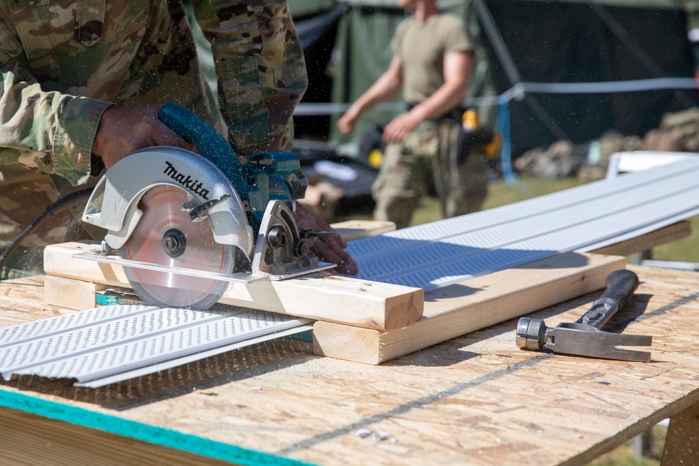 Soldier cuts new soffit for restoration of building