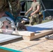 Soldier cuts new soffit for restoration of building