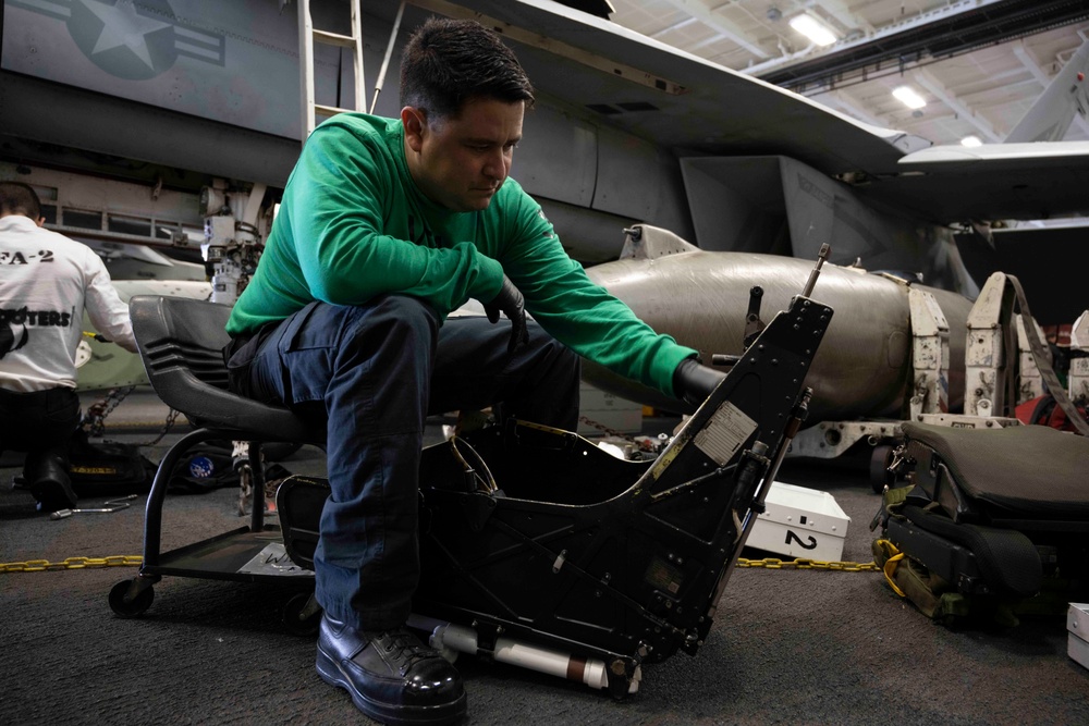 USS Carl Vinson (CVN 70) Sailor Cleans an F/A-18F Super Hornet seat.