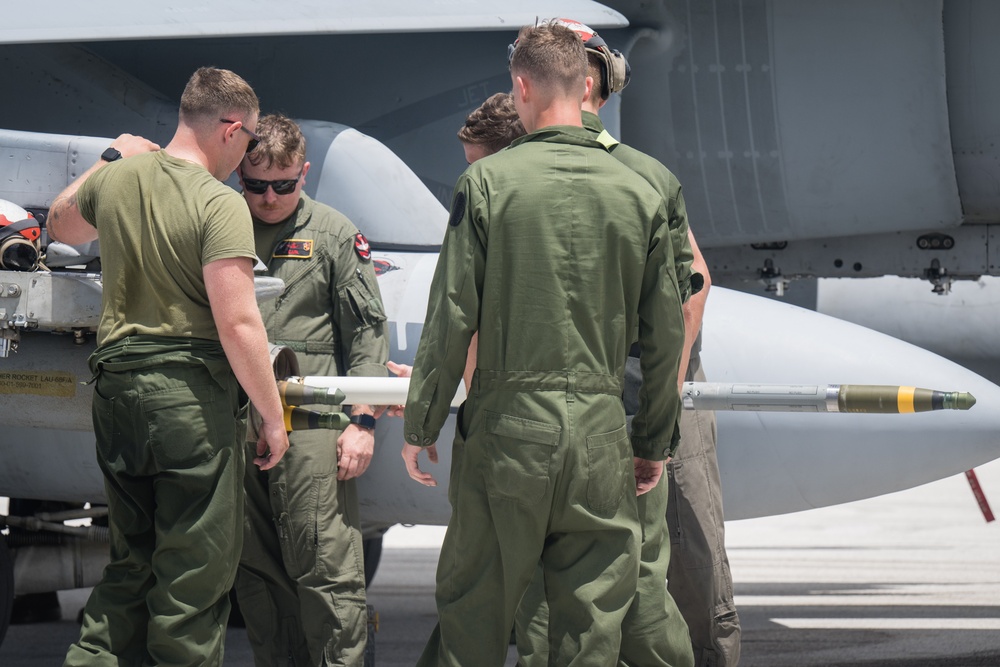 Marine All-Weather Fighter Attack Squadron (VMFA(AW)) 224 loads ordnance onto F/A-18 Hornet aircraft