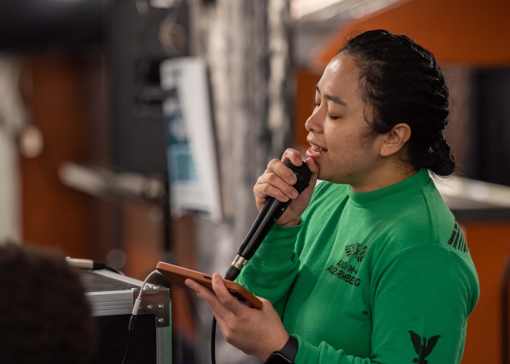 USS Ronald Reagan (CVN 76) Sailors participate in karaoke night hosted by Morale,  Welfare, and Recreation