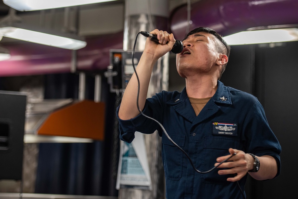 USS Ronald Reagan (CVN 76) Sailors participate in karaoke night hosted by Morale,  Welfare, and Recreation