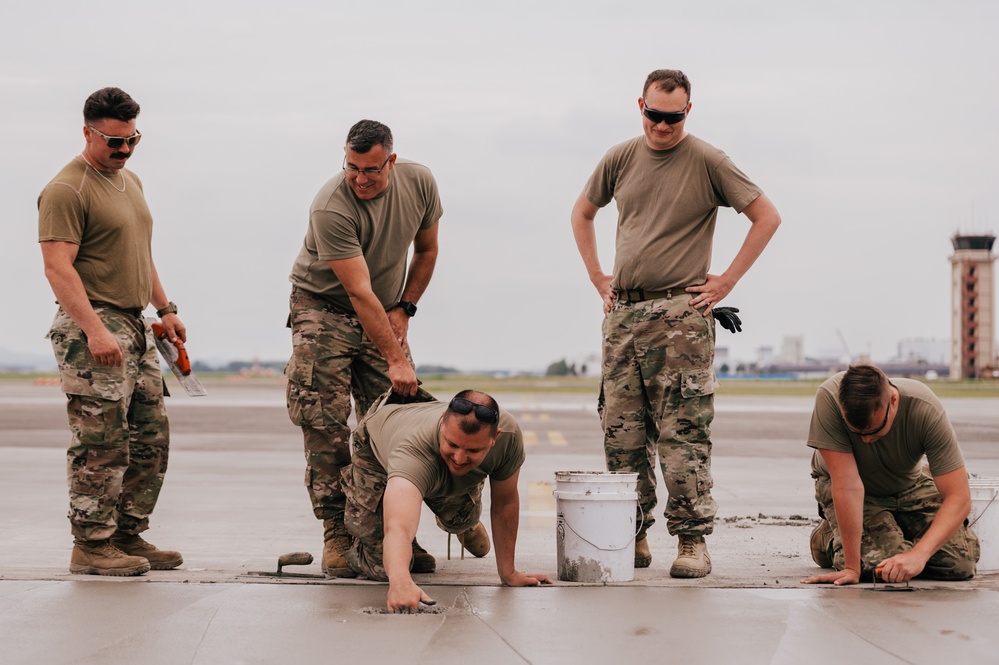 The 139th Civil Engineer Squadron lay concrete for ramp extention