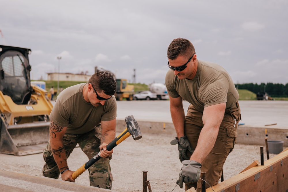 The 139th Civil Engineer Squadron lay concrete for ramp extention