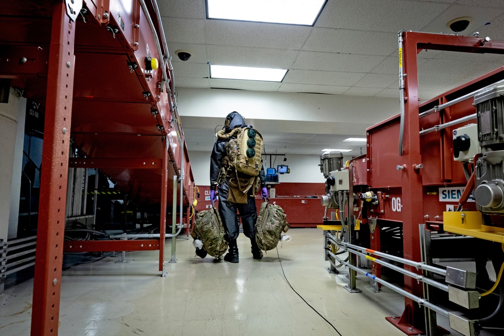 An EOD Technician Approaches a Simulated IED During an Airport Drill