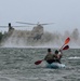 Competitors in the 2024 U.S. Army Special Operations Command (USASOC) Best Combat Diver Team Competition take part in a kayak race following a helocast