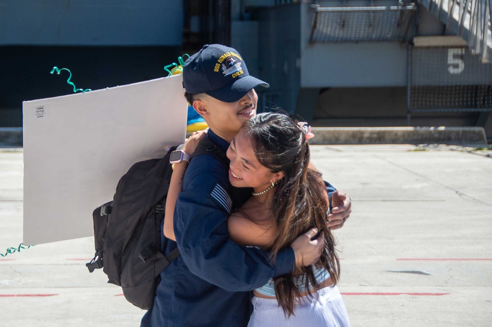USS Ronald Reagan (CVN 76) Sailors greet family on the pier after arriving at Naval Base Guam for scheduled port visit