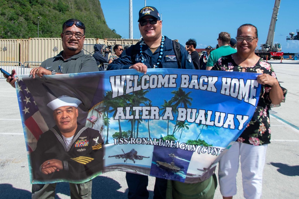 USS Ronald Reagan (CVN 76) Sailors greet family on the pier after arriving at Naval Base Guam for scheduled port visit